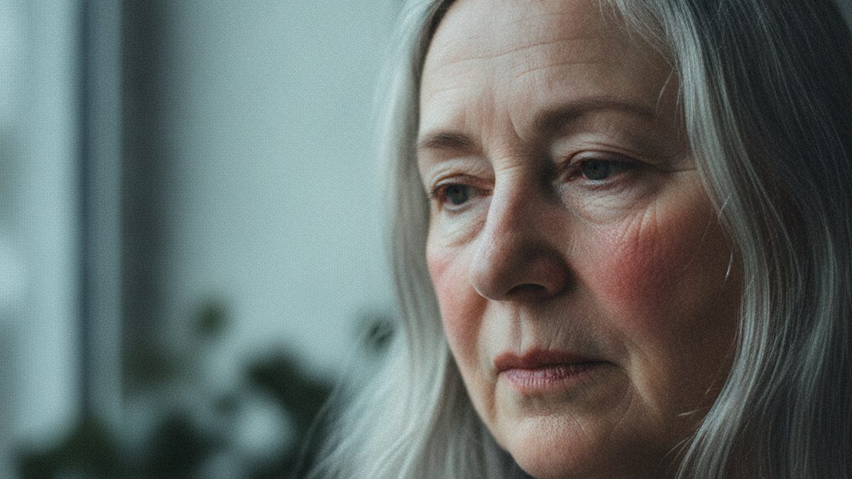 Contemplative older woman in soft window light, illustrating cGAS-STING and age-related inflammation of the aging brain